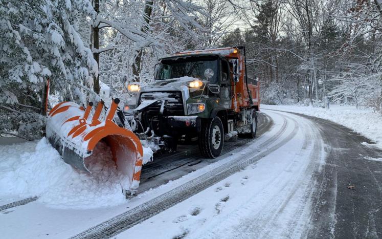 Town of Simsbury plow truck driving down a snowy street